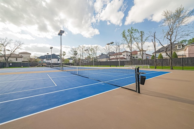 view of sport court with a residential view, community basketball court, and fence