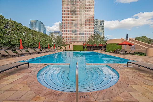 pool featuring a patio area and a view of city