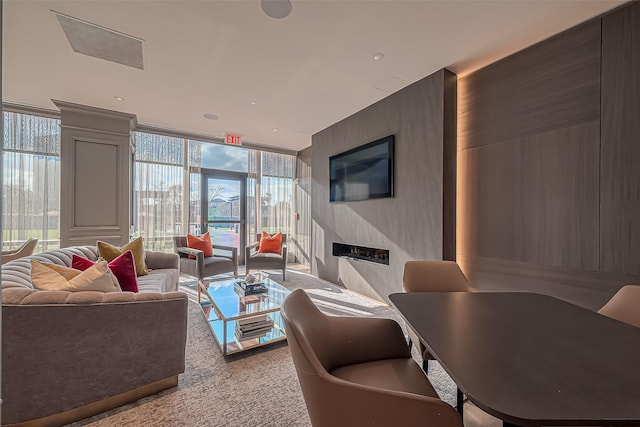 living room with expansive windows, carpet flooring, and a fireplace