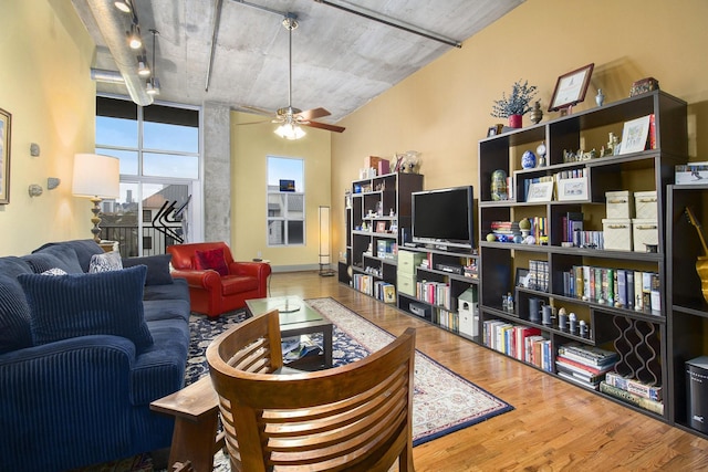 living room featuring a ceiling fan and wood finished floors