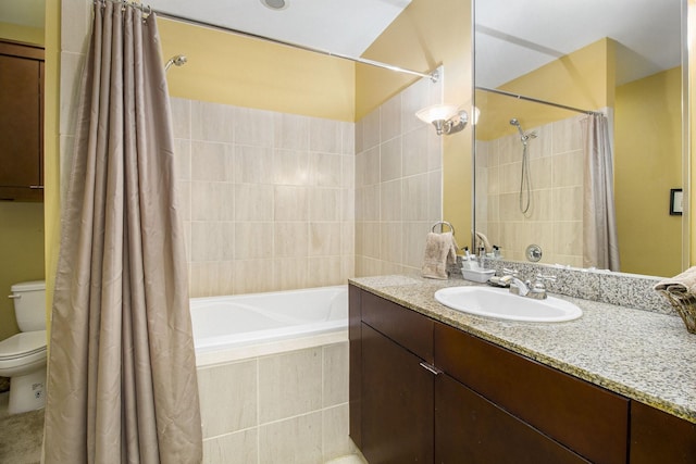 full bath featuring tiled shower / bath, toilet, and vanity