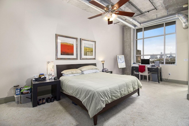 carpeted bedroom with baseboards, a high ceiling, and ceiling fan