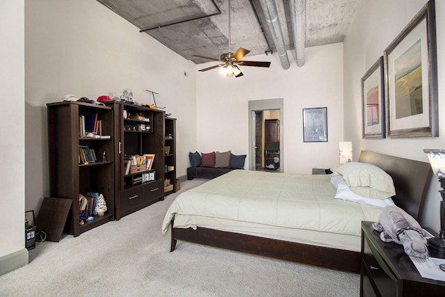 bedroom featuring a high ceiling, ceiling fan, and carpet flooring