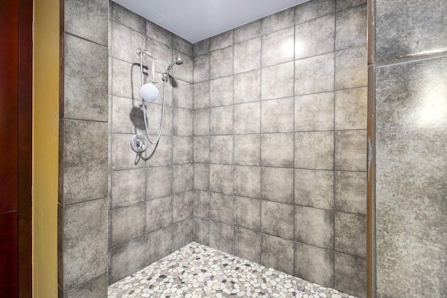 full bath with a tile shower