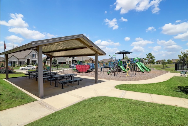 view of home's community featuring a lawn and playground community