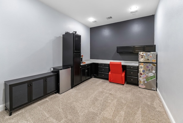 office space featuring visible vents, baseboards, and light colored carpet