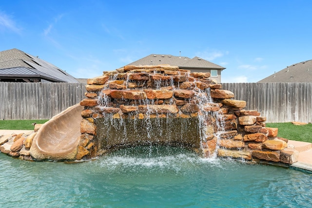 view of pool featuring fence