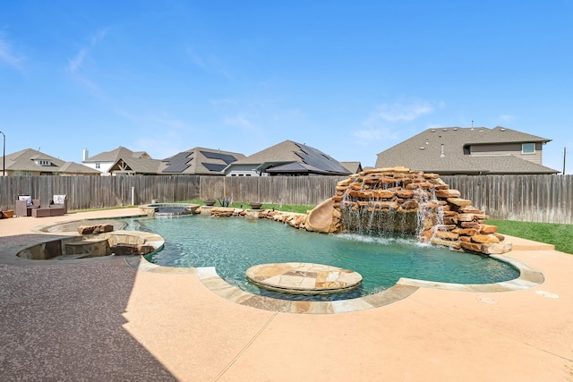 view of swimming pool with a patio, a fenced backyard, and a pool with connected hot tub