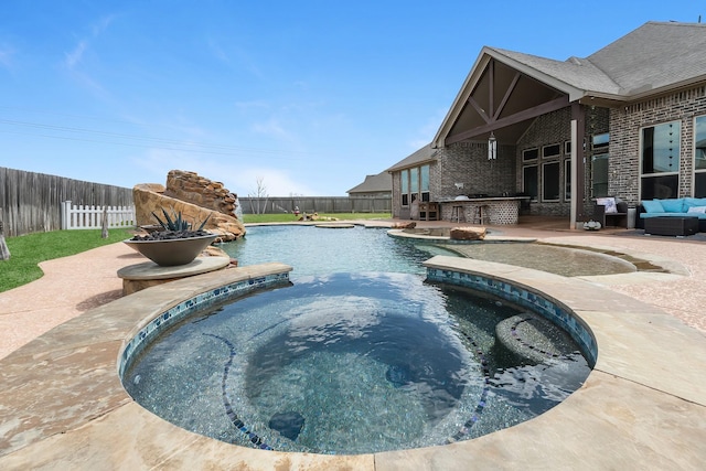 view of swimming pool with a patio, a fenced backyard, outdoor dry bar, and outdoor lounge area