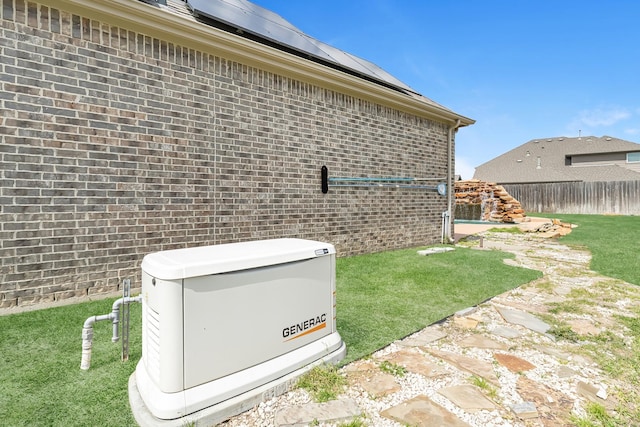 exterior details with a power unit, brick siding, and fence