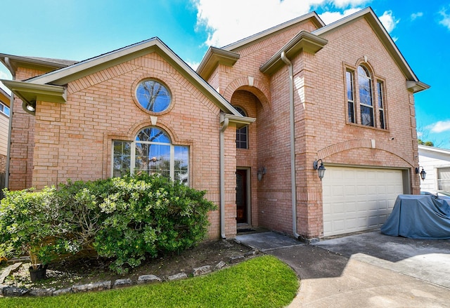 view of front of house featuring brick siding, concrete driveway, and an attached garage