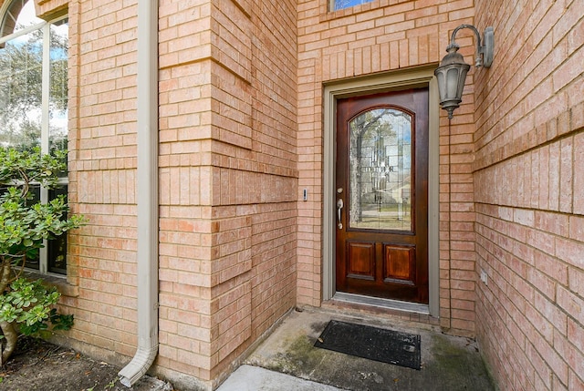 doorway to property with brick siding