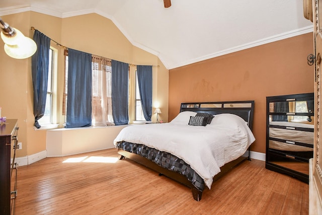 bedroom with baseboards, lofted ceiling, ornamental molding, and hardwood / wood-style flooring