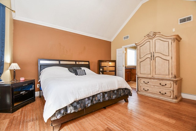 bedroom with visible vents, baseboards, light wood-style floors, and crown molding