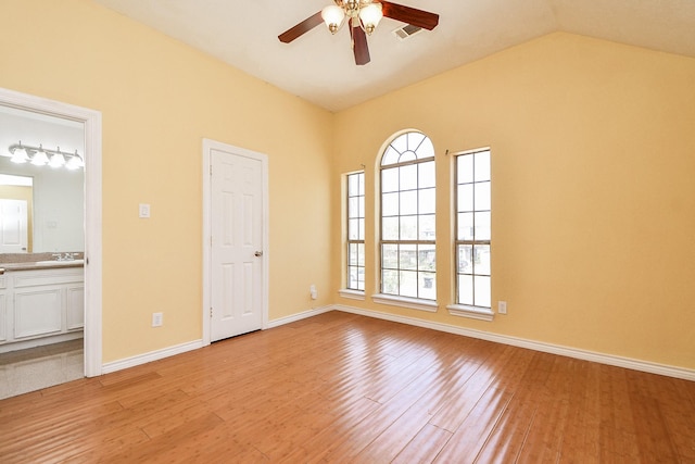 spare room featuring light wood-type flooring, visible vents, plenty of natural light, and ceiling fan