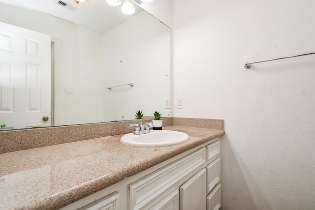 bathroom featuring visible vents and vanity