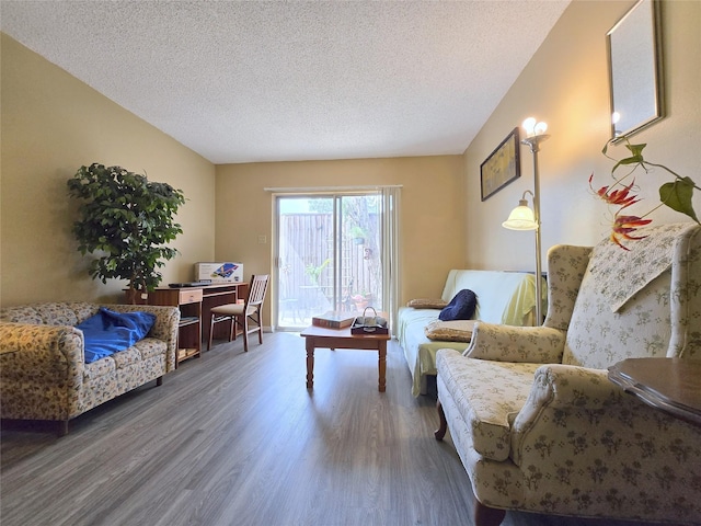 living room with wood finished floors and a textured ceiling