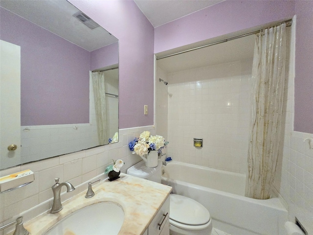 full bath featuring visible vents, toilet, tile walls, and vanity