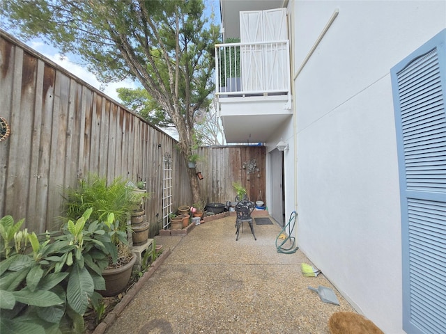 view of patio / terrace with a balcony and a fenced backyard