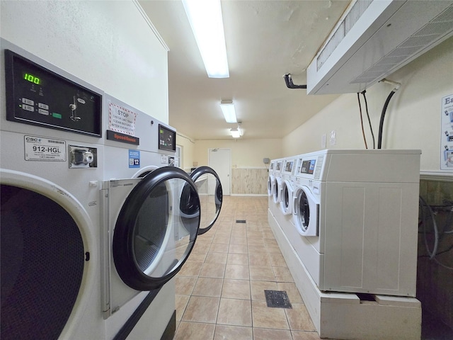 common laundry area with light tile patterned floors and washer and dryer