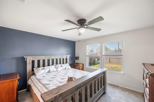 carpeted bedroom featuring a ceiling fan and baseboards