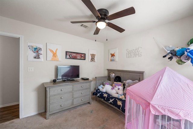 carpeted bedroom featuring visible vents, baseboards, and a ceiling fan