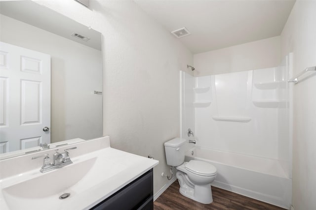 bathroom featuring visible vents, toilet, wood finished floors, and vanity