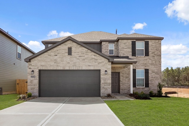 view of front facade with driveway, fence, a front yard, a garage, and brick siding