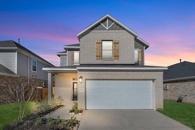 view of front of property with an attached garage, brick siding, and driveway