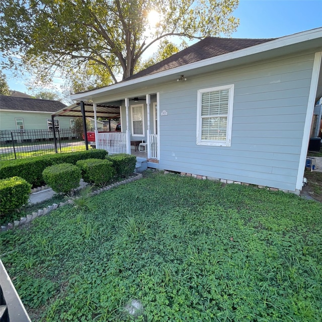 exterior space with a porch, a front yard, and fence