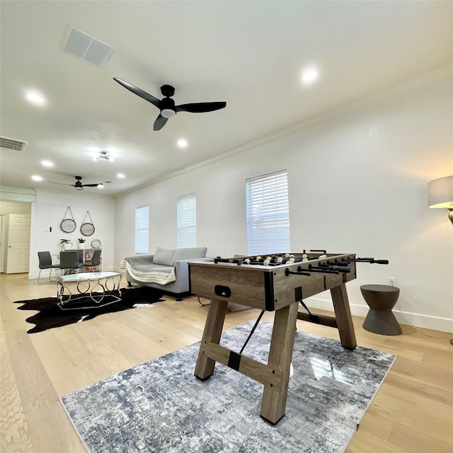 playroom featuring visible vents, a ceiling fan, and wood finished floors