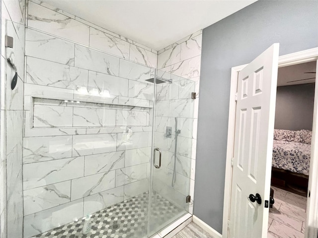 bathroom featuring a shower stall, baseboards, marble finish floor, and connected bathroom