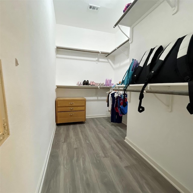 walk in closet featuring wood finished floors and visible vents