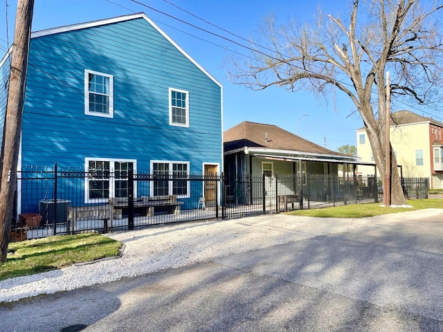 rear view of house with a fenced front yard