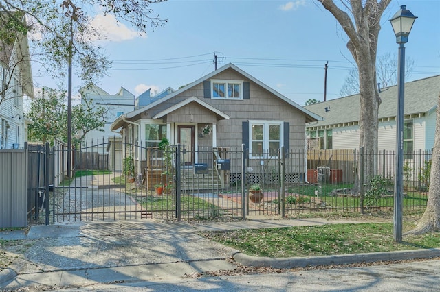 view of front facade with a fenced front yard and a gate