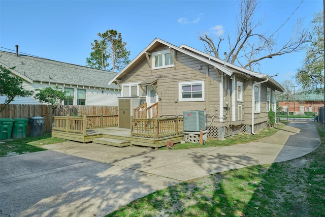 1111 Rutland St, Houston, TX 77008 - back of property with central air condition unit, driveway, fence, and a deck