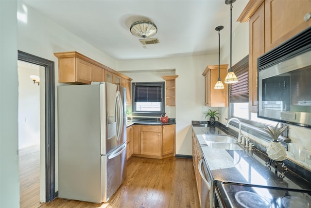 kitchen featuring visible vents, a sink, light wood-style flooring, appliances with stainless steel finishes, and open shelves