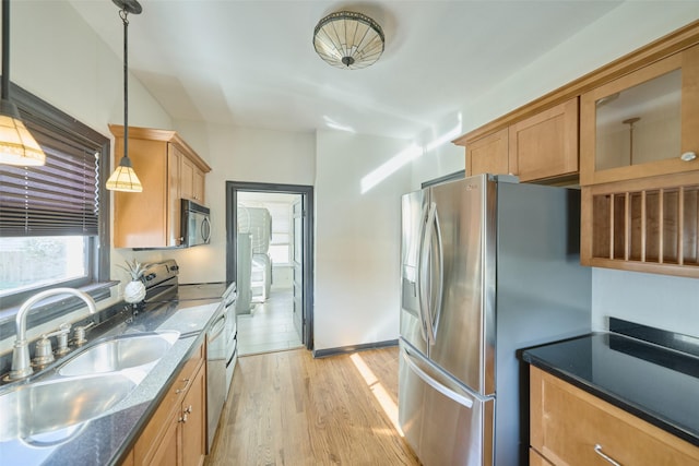 kitchen with dark stone countertops, light wood finished floors, range with electric cooktop, a sink, and stainless steel refrigerator with ice dispenser