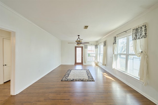 entryway with visible vents, ornamental molding, baseboards, ceiling fan, and dark wood-style flooring