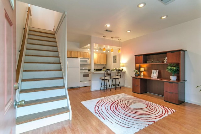 entrance foyer featuring light wood-type flooring, visible vents, recessed lighting, stairway, and baseboards