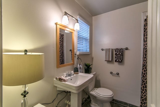 bathroom featuring toilet and a shower with shower curtain