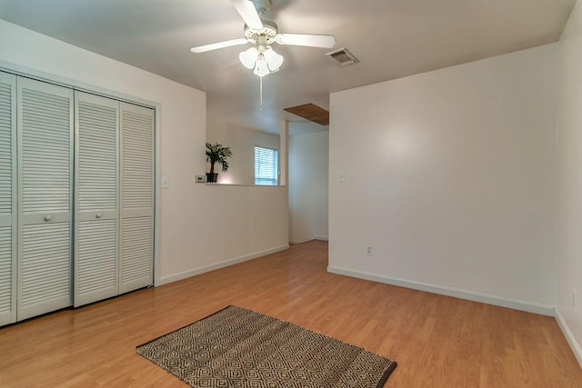 unfurnished bedroom with visible vents, a closet, light wood-style floors, baseboards, and ceiling fan