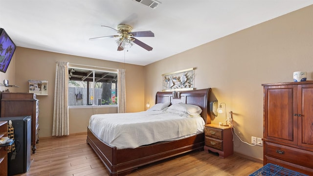 bedroom with visible vents, baseboards, light wood-type flooring, and ceiling fan