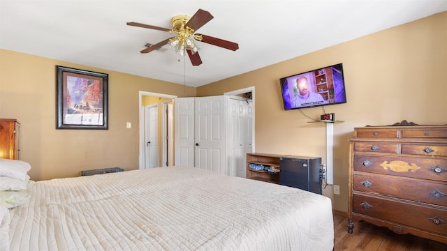 bedroom featuring wood finished floors, a closet, and ceiling fan