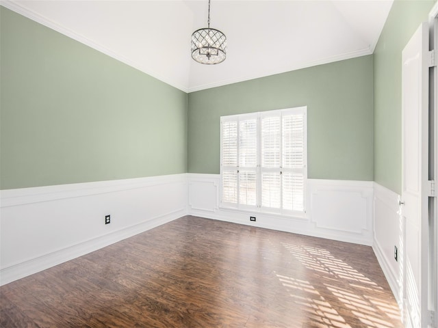 unfurnished room with a chandelier, a wainscoted wall, lofted ceiling, and wood finished floors