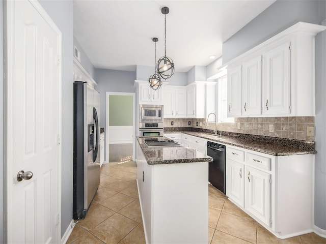 kitchen with a kitchen island, light tile patterned flooring, a sink, black appliances, and white cabinetry