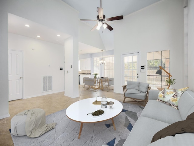 living room featuring visible vents, light tile patterned floors, ceiling fan with notable chandelier, recessed lighting, and a towering ceiling