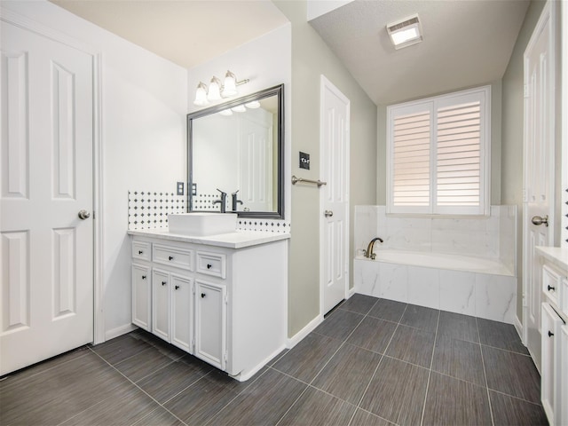 bathroom featuring vanity, a bath, and visible vents