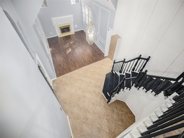 staircase featuring wood finished floors and a fireplace