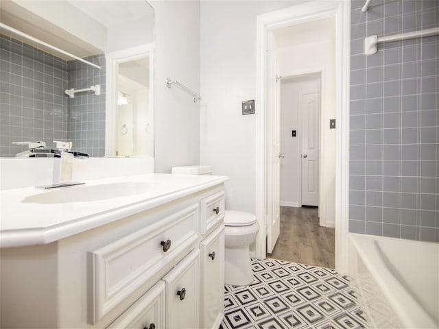 full bath with toilet, vanity, and  shower combination